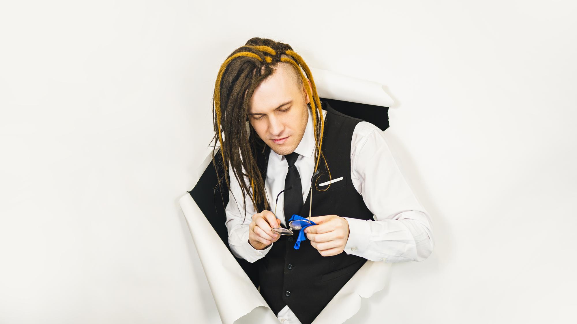 Instructor showing embroidery sample in studio