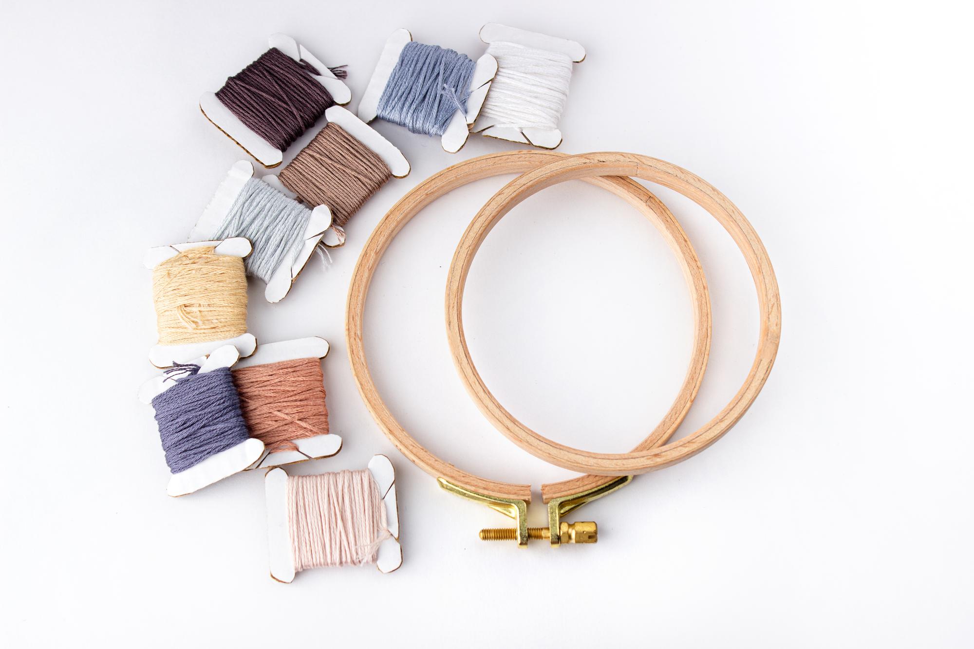 Array of embroidery hoops overlapping on table